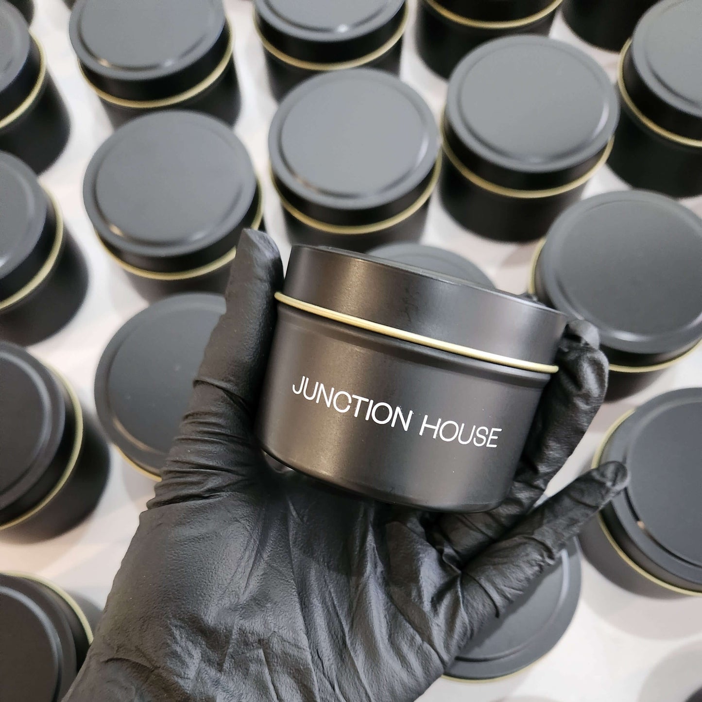 Branded 4oz matte black tin candle for corporate events and promotional giveaways.