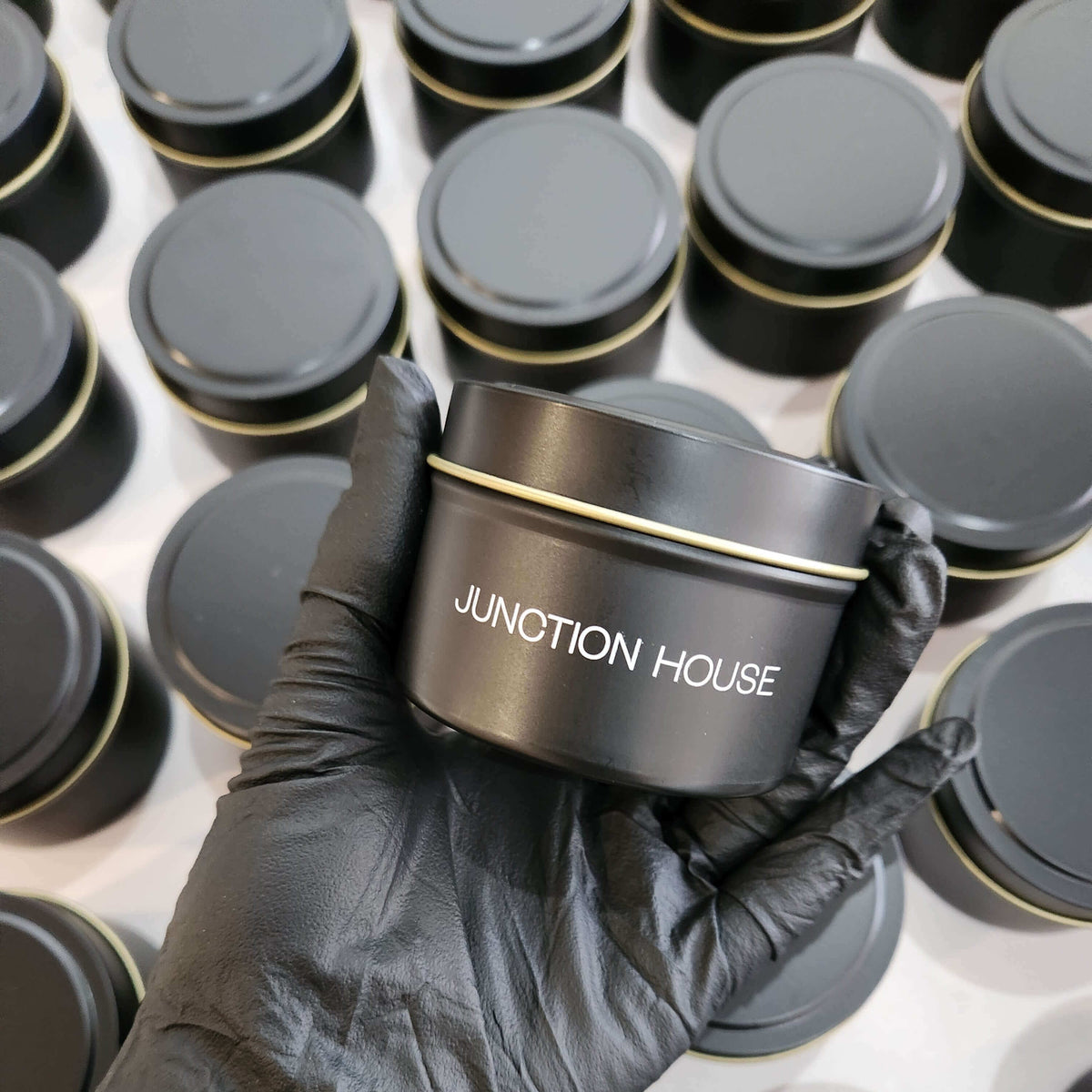 Branded 4oz matte black tin candle for corporate events and promotional giveaways.