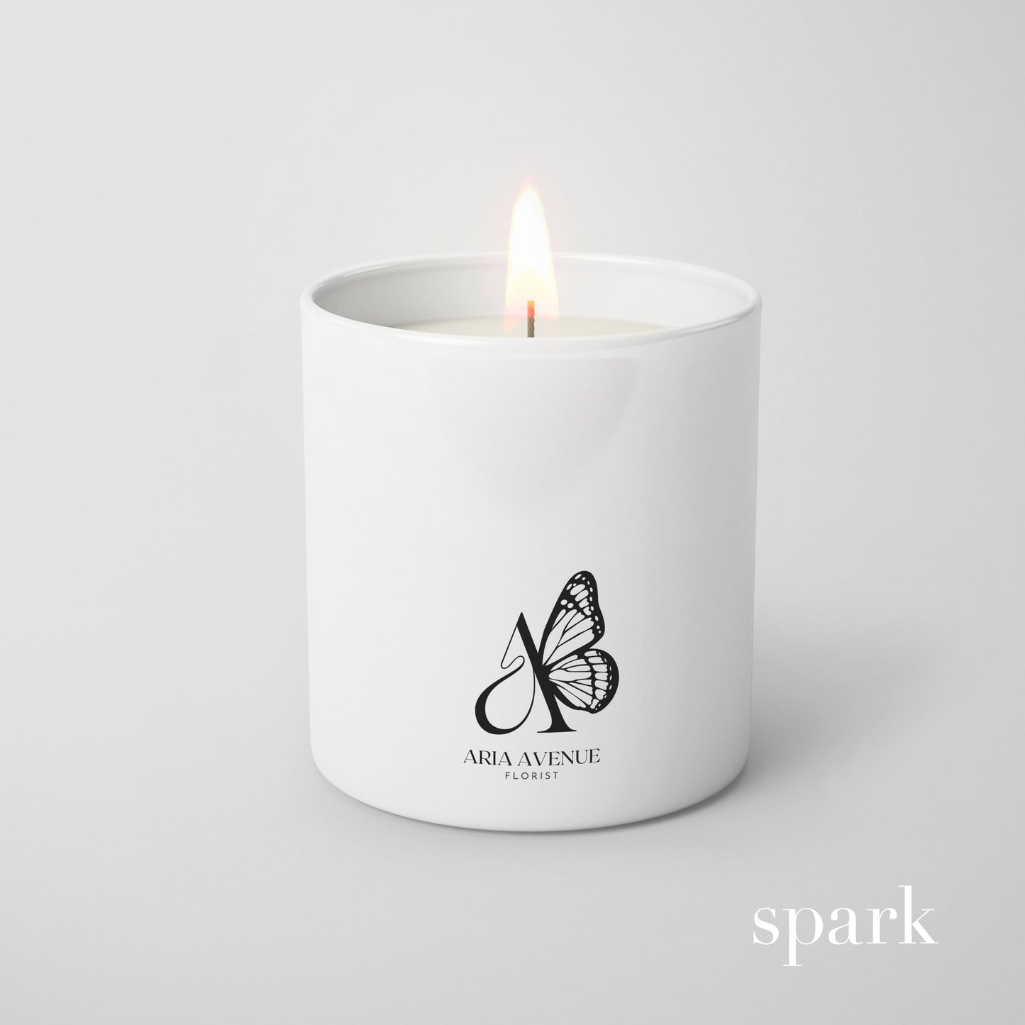 Custom branded matte white glass candle produced by a candle manufacturer for client gifts and events.