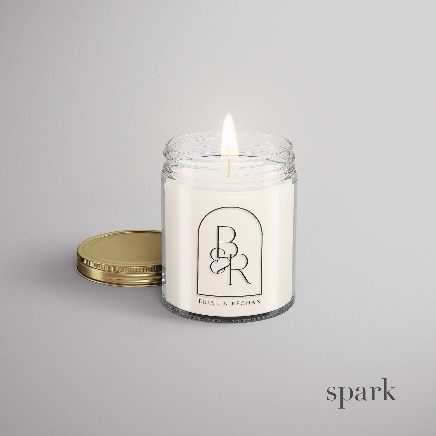 Candle in a jar with a visible custom branded logo on a gray background