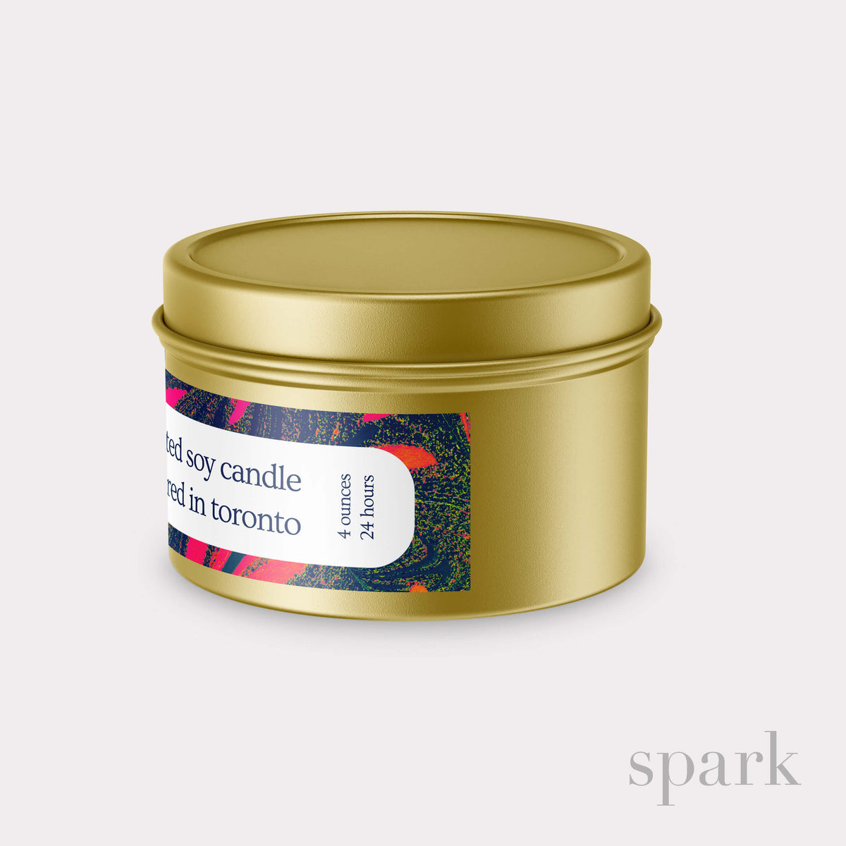 Gold candle tin with a colorful label on a light gray background
