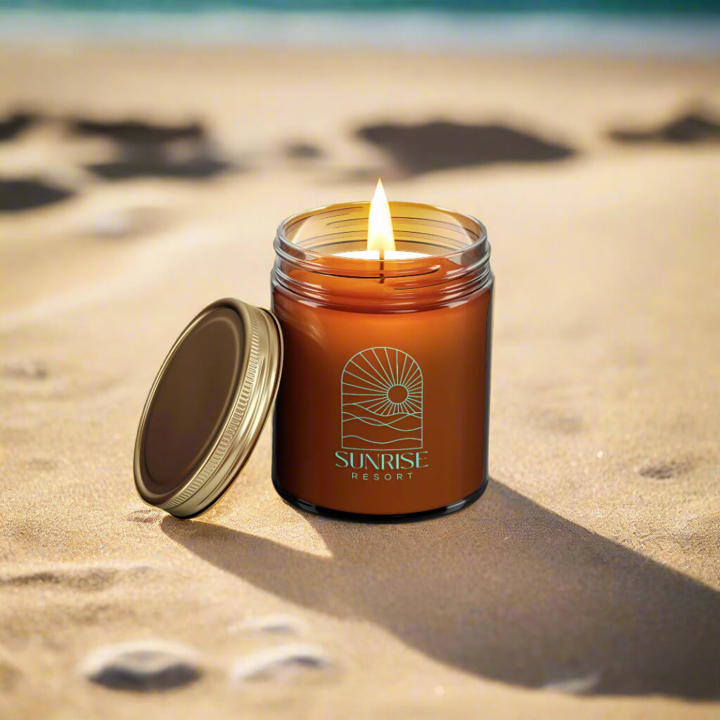 Custom Amber Glass Candle on the Beach with Branded Sunrise Logo Imprint and Gold Lid