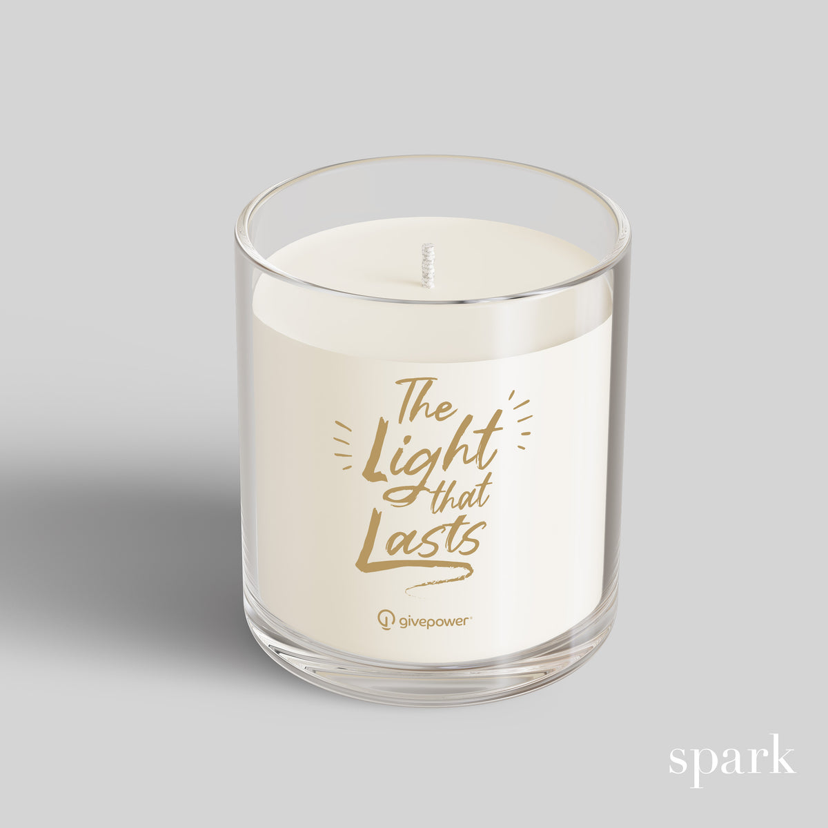 Candle in a glass jar with 'The Light That Lasts' text on a gray background