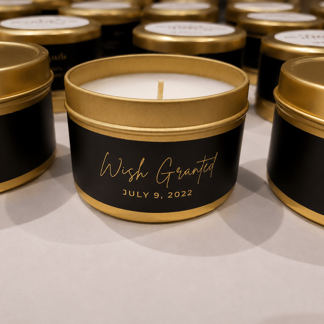 Candle in a black and gold tin with 'Wish Granted' and date on a light background