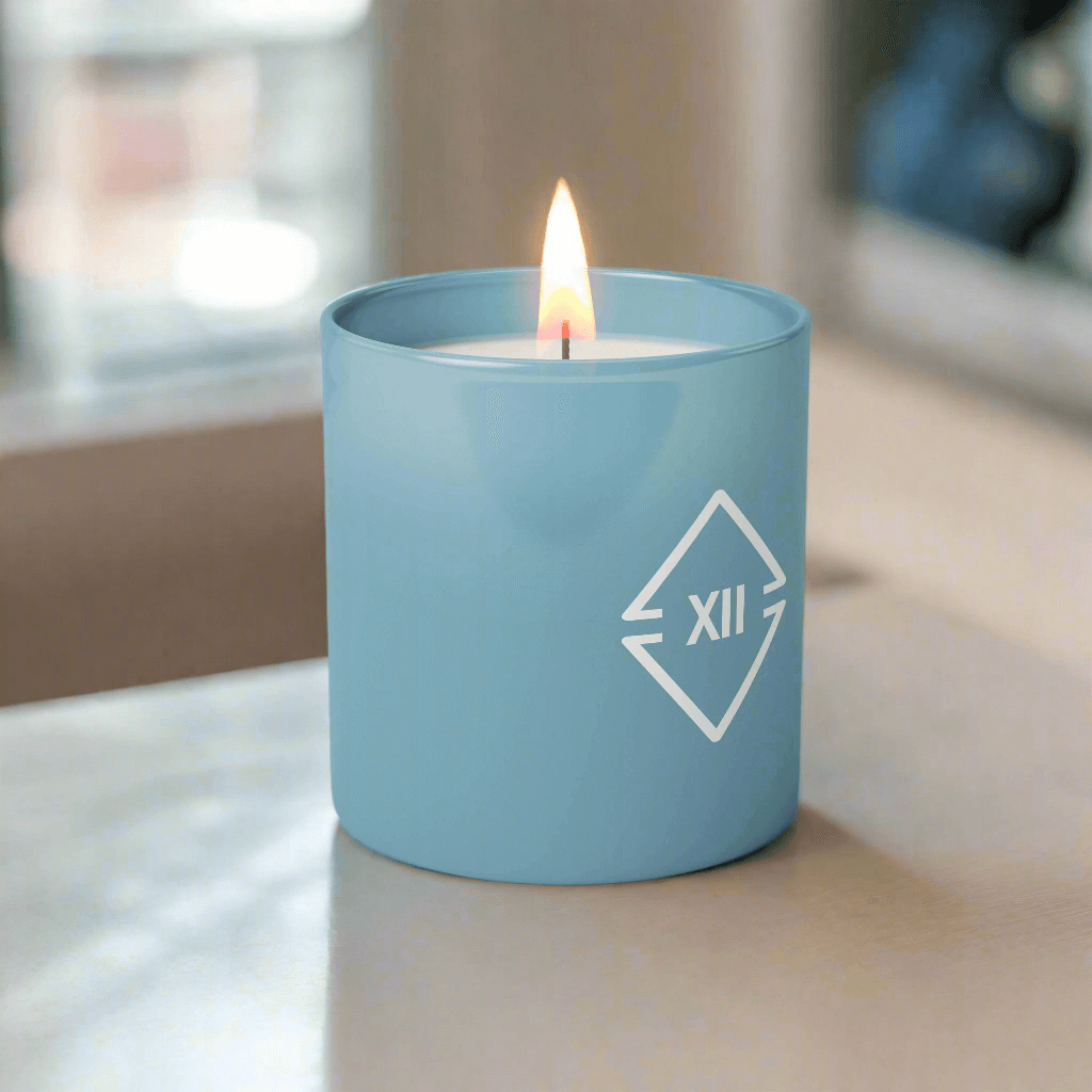 Custom branded blue candle with corporate logo imprint on a desk